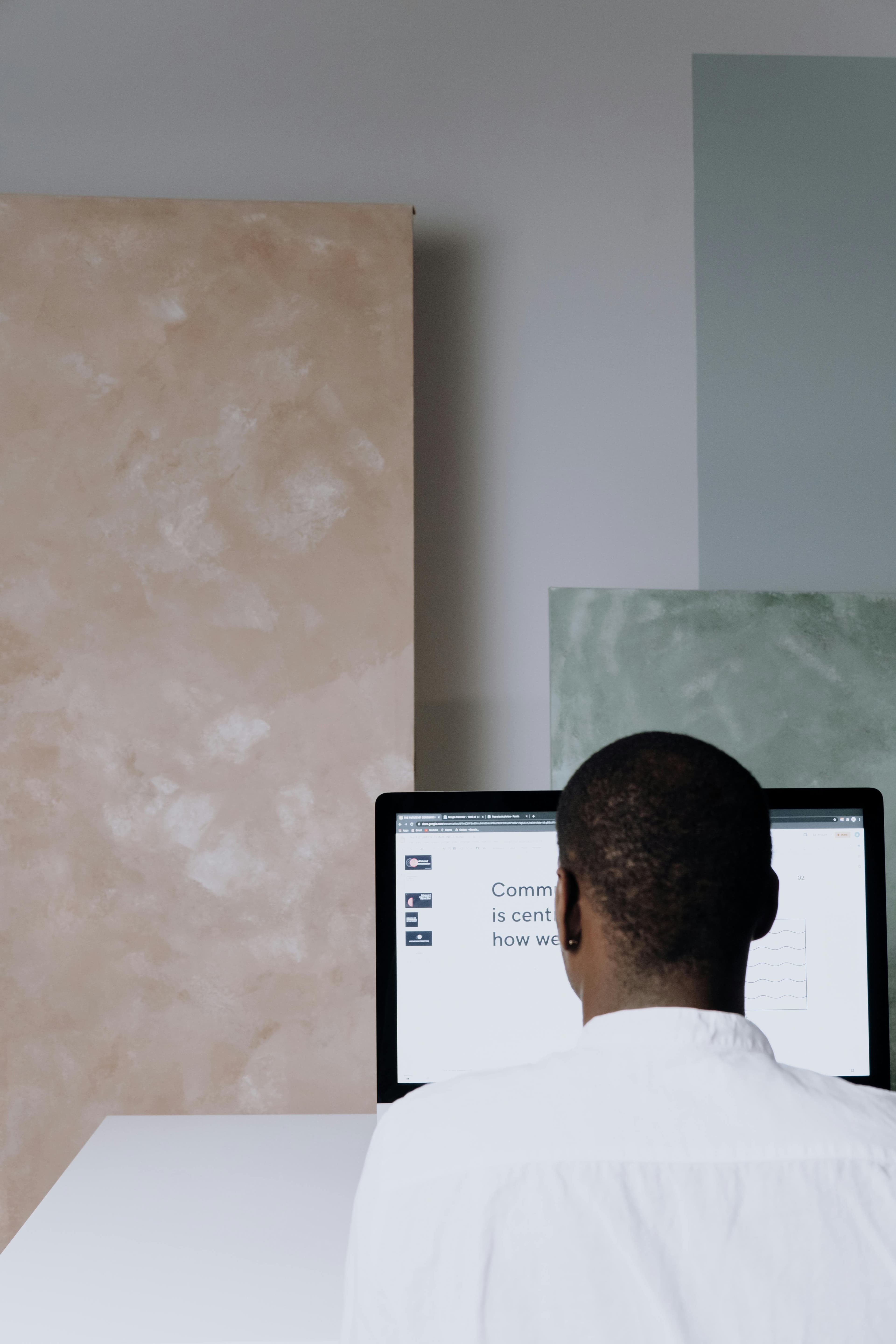 Editorial portrait of a person working at a laptop in a quiet, well-lit office.